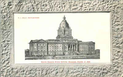 Black-and-white image of the capitol in a wide frame